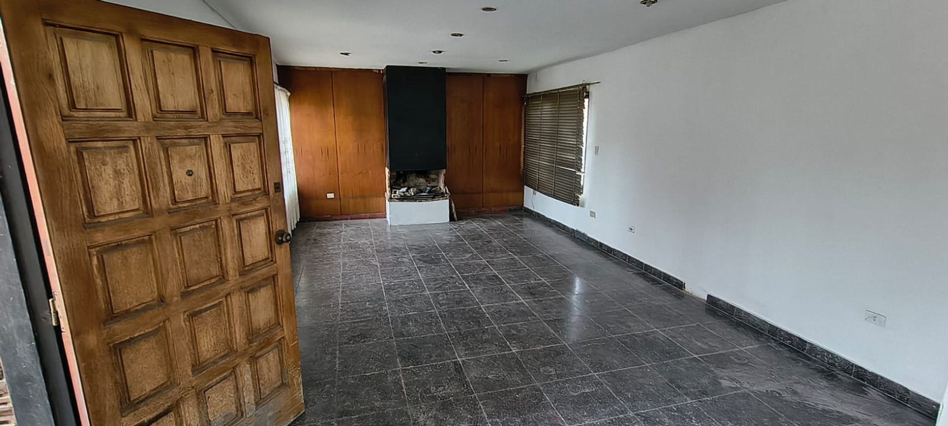 02 - Living comedor principal con hogar a leña y revestimiento de madera